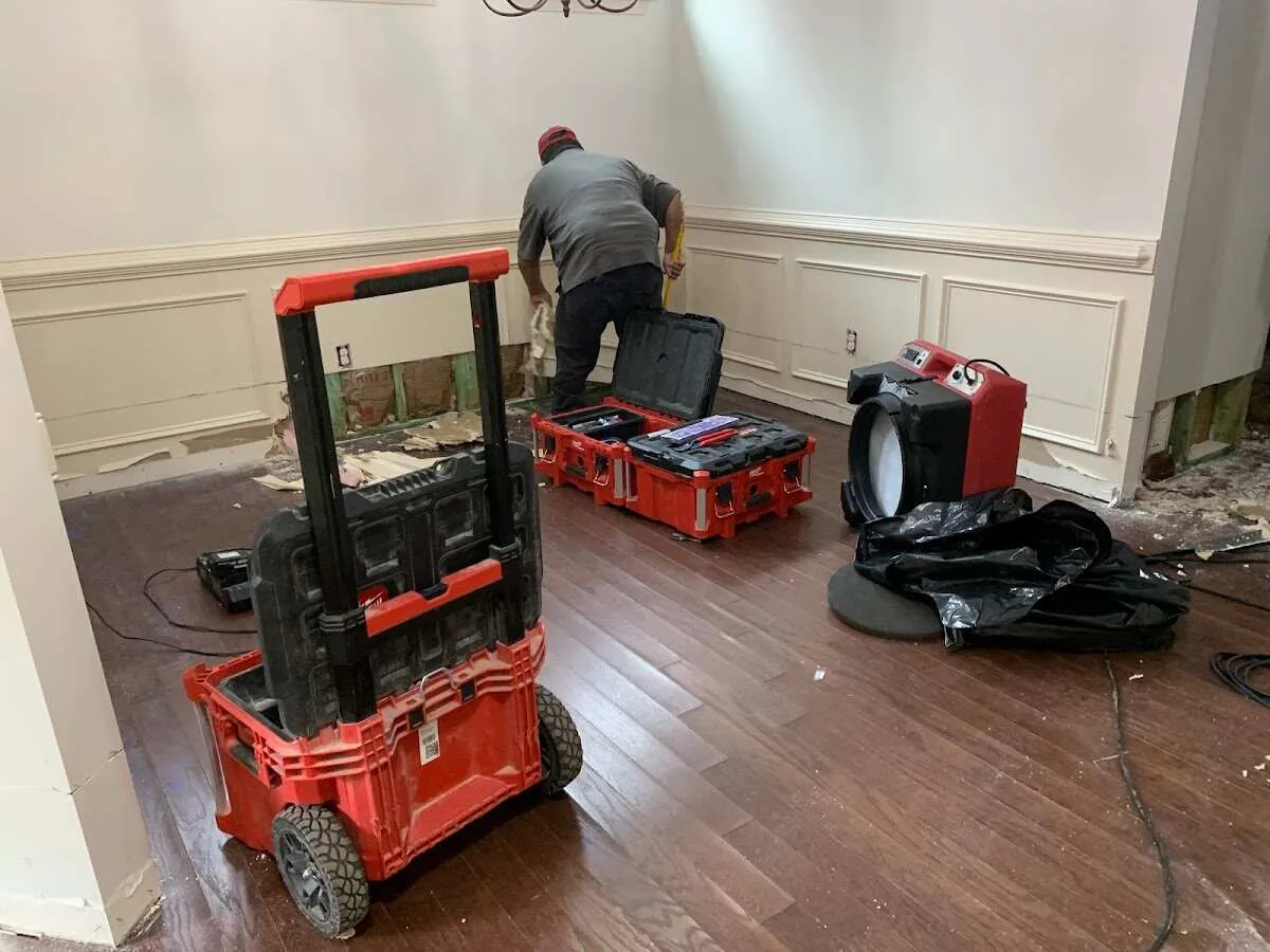 Technician setting up drying equipment for water damage in Mammoth Lakes